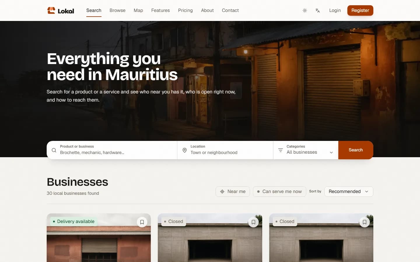 Lokal on the web: “Everything you need in Mauritius” over a shopfront at dusk, one search bar for a product or business, a location and a category, and 30 local businesses found, with the “Near me” and “Can serve me now” filters.